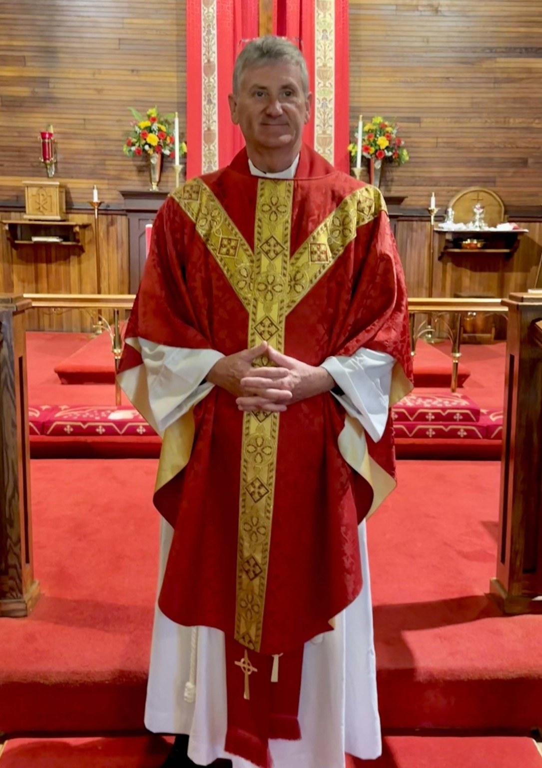 Fr. Ken Shradar in red and gold vestments