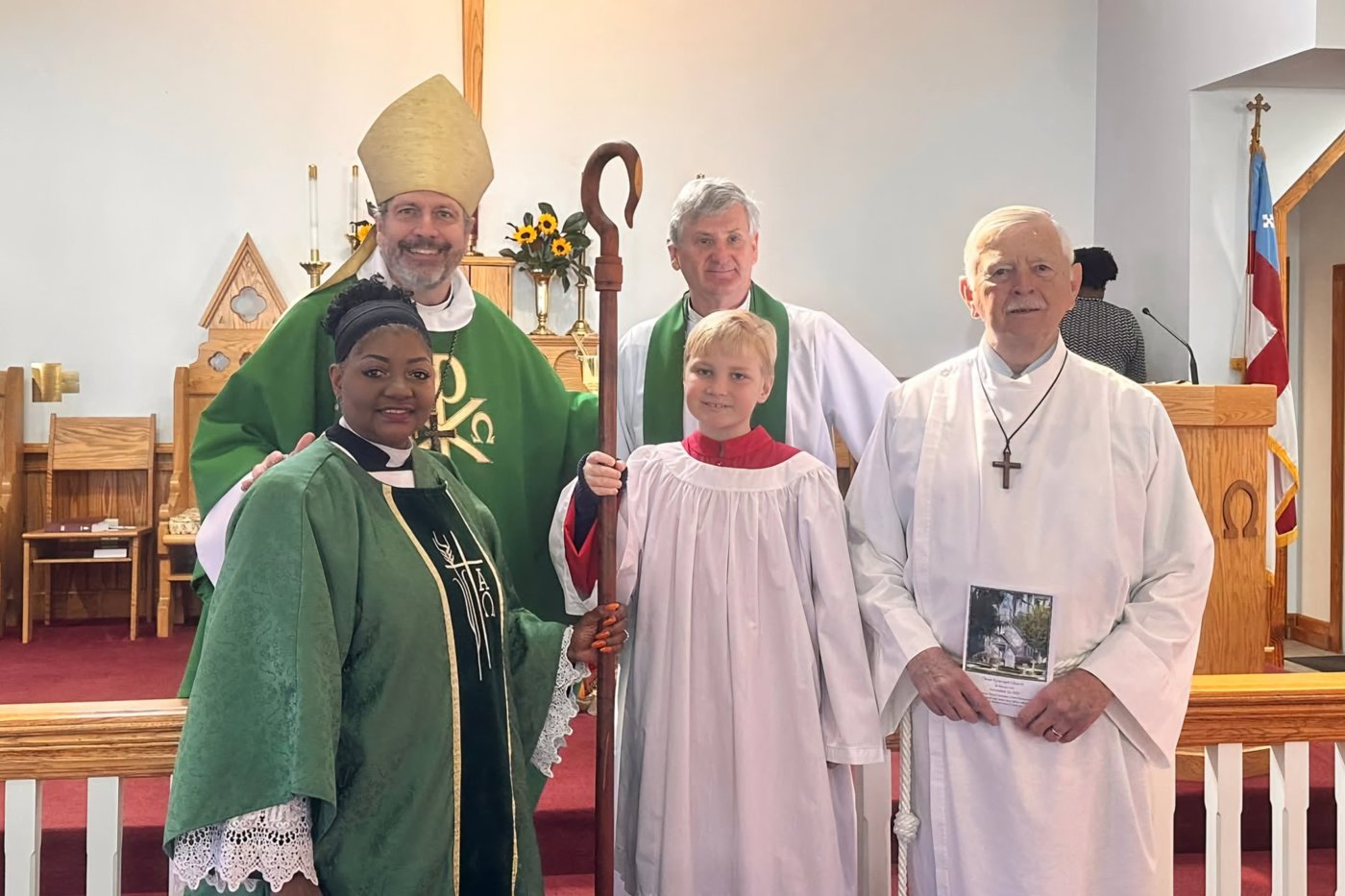 Clergy and worship participants gathered at the altar