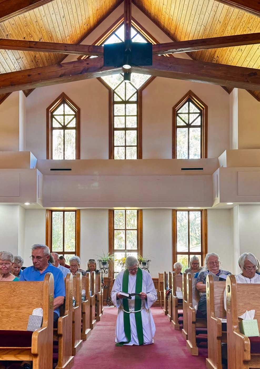 Church interior facing the rear windows and center aisle